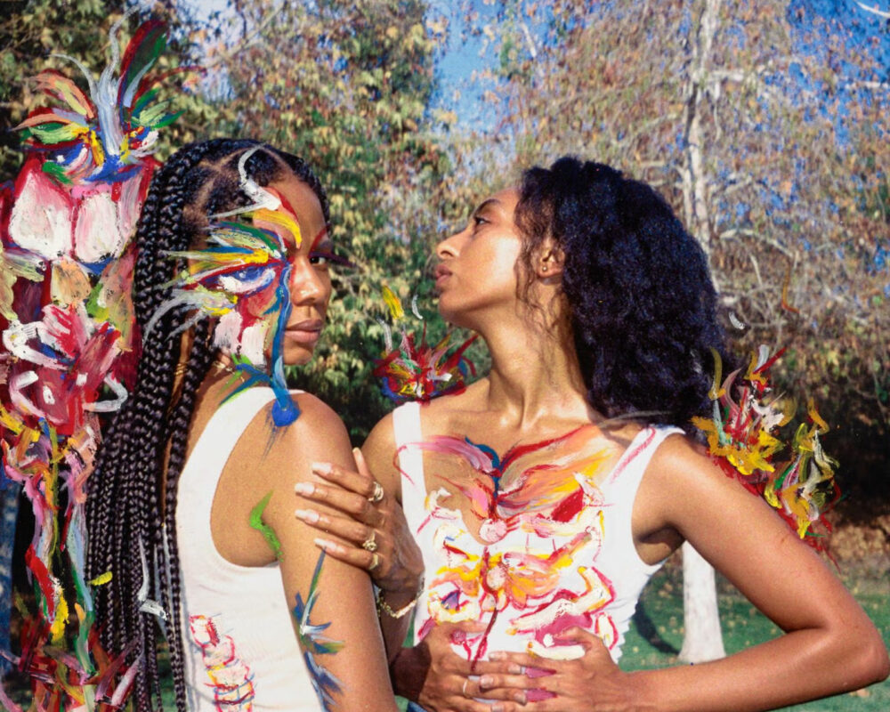 Women laughing and lounging outdoors during a girls' trip, surrounded by nature and good vibes