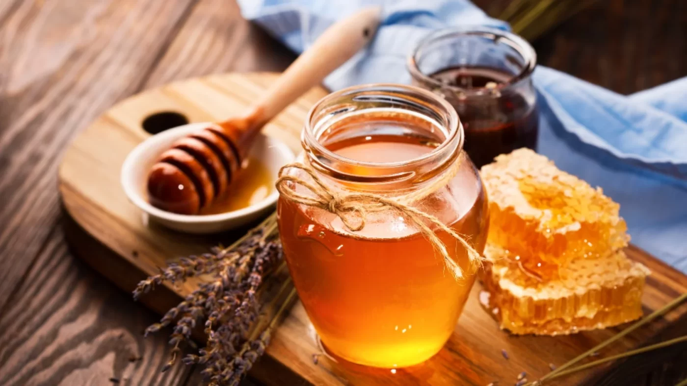 Jar of infused honey with blue tint, representing magic mushroom (psilocybin) infusion
