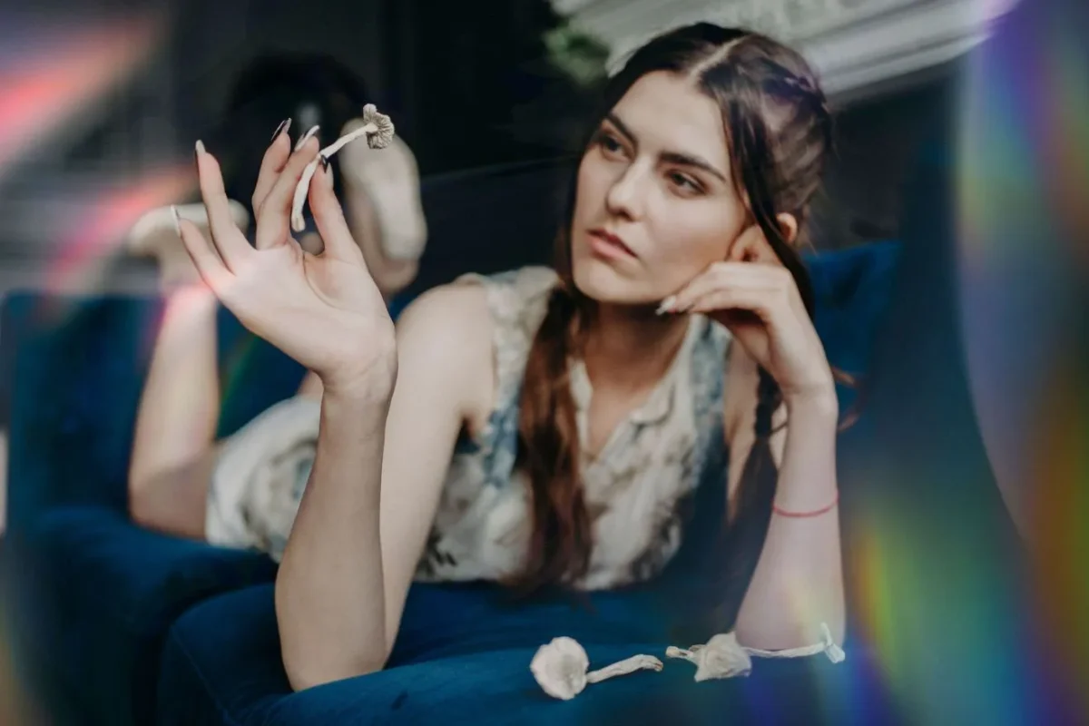 Person resting in bed at night after a psilocybin mushroom experience, illustrating post-trip insomnia and recovery